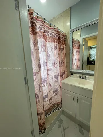 a bathroom with a shower and a sink