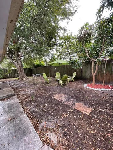 a view of a backyard with large trees