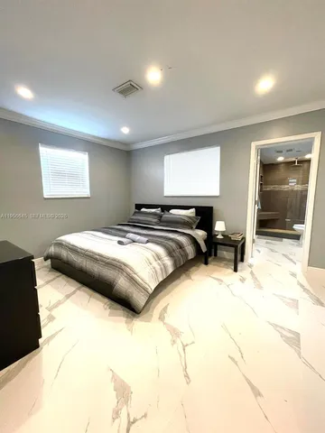 a bedroom with double bed and a large mirror