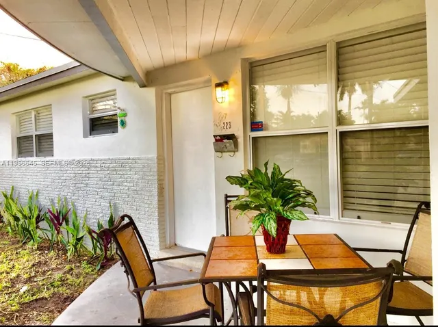 a view of a balcony with table and chairs