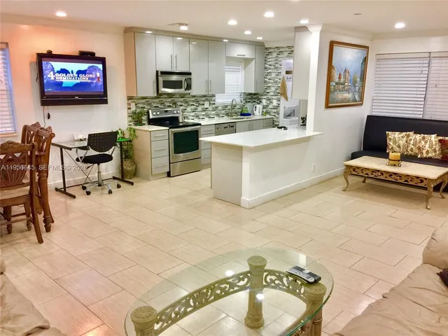 a large kitchen with a table and chairs