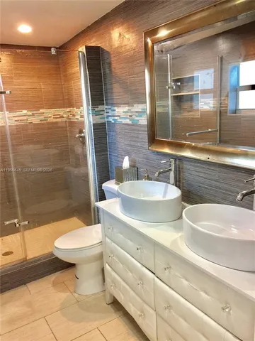 a bathroom with a sink toilet and shower