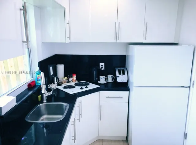 a kitchen with a sink cabinets and a stove