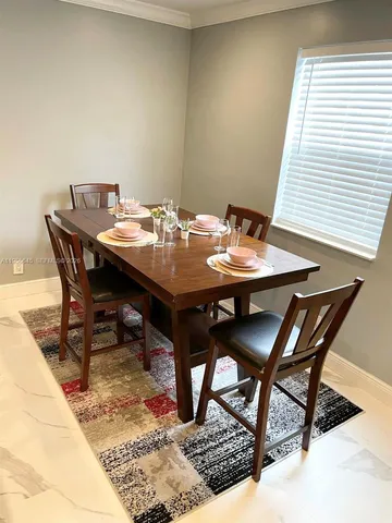 a view of a dining table and chairs in a patio