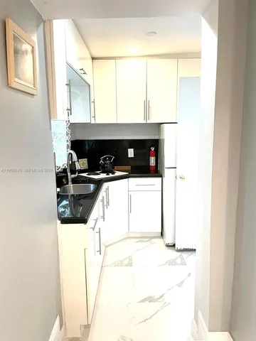 a kitchen with a sink a stove and a refrigerator