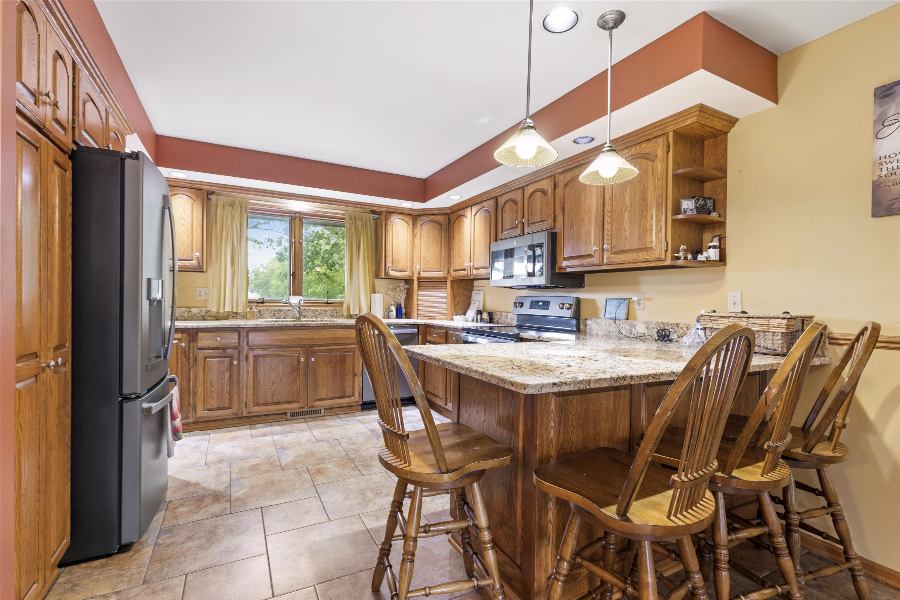 3410 Rotary Road Rockford, IL 61109 - Photo 13 of 65 a kitchen with a sink and chairs