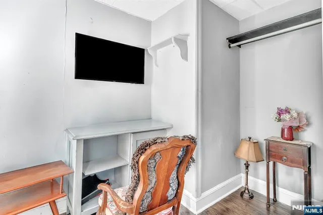 a bedroom with a bed and a television