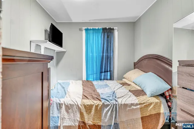 a kitchen with stainless steel appliances kitchen island granite countertop a table chairs refrigerator and microwave