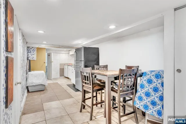 a view of a dining room with furniture and a flat screen tv