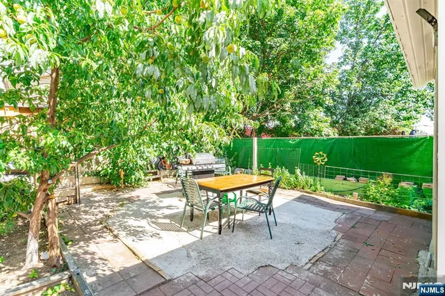 a view of a backyard with sitting area