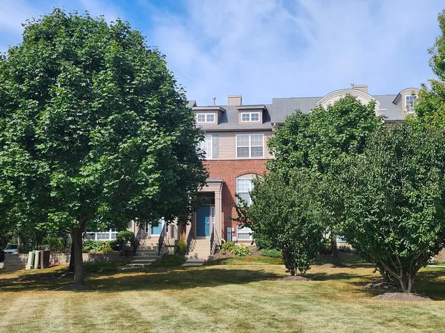 a view of a building with trees in front of it