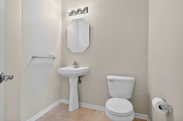 a view of a kitchen with white cabinets