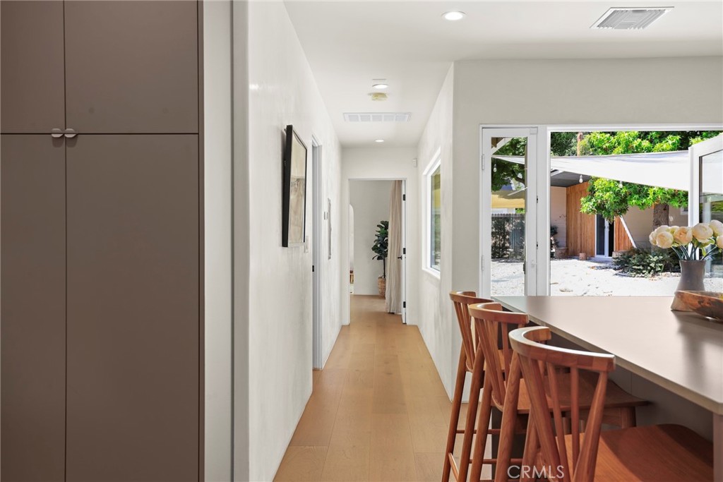 1445 Paloma Street Pasadena, CA 91104 - Photo 12 of 44 a view of a hallway with wooden floor and windows
