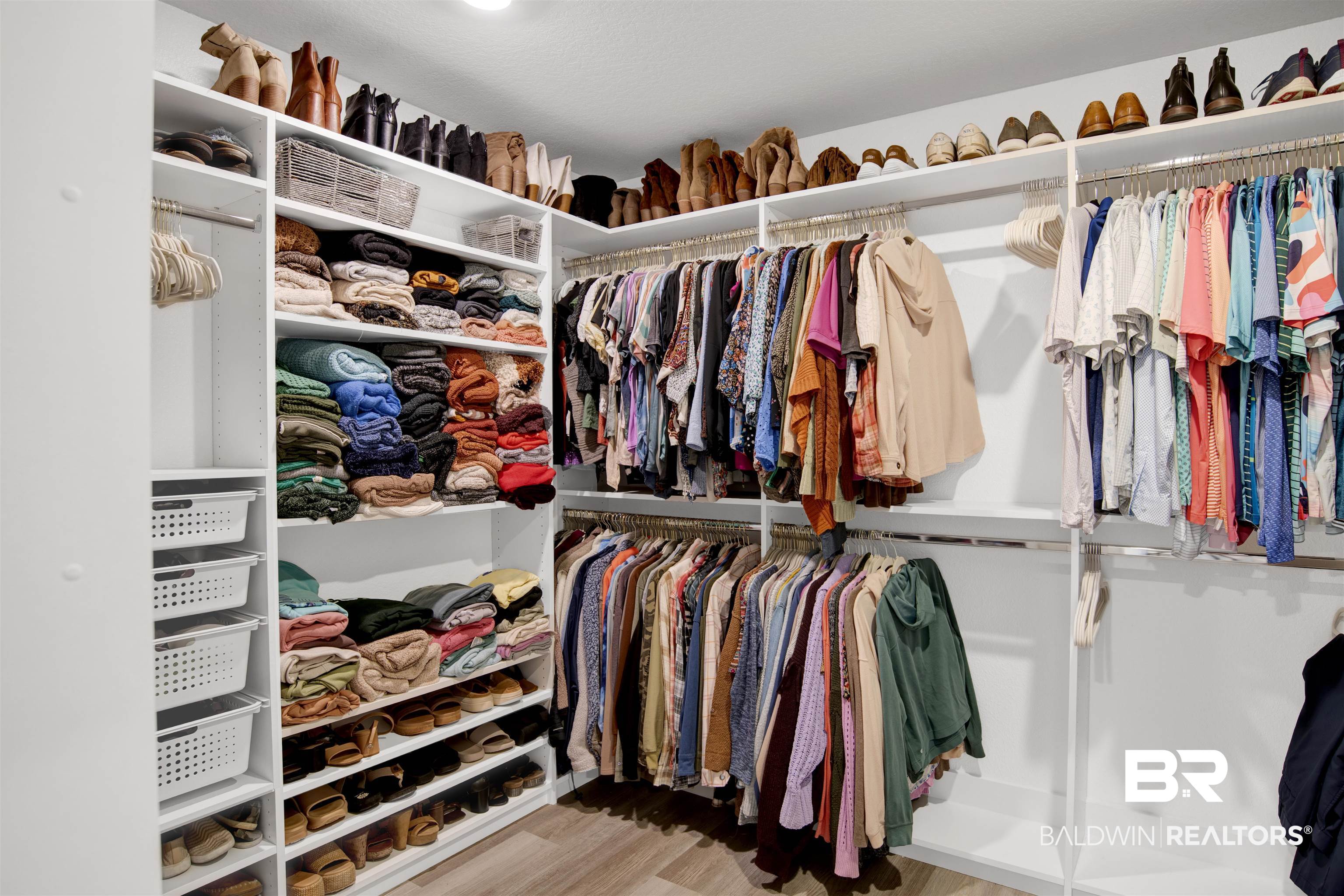 22301 Early Dawn Circle Foley, AL 36535 - Photo 16 of 45 Custom closet system featuring extensive shelving, multiple hanging rods, and integrated shoe storage
