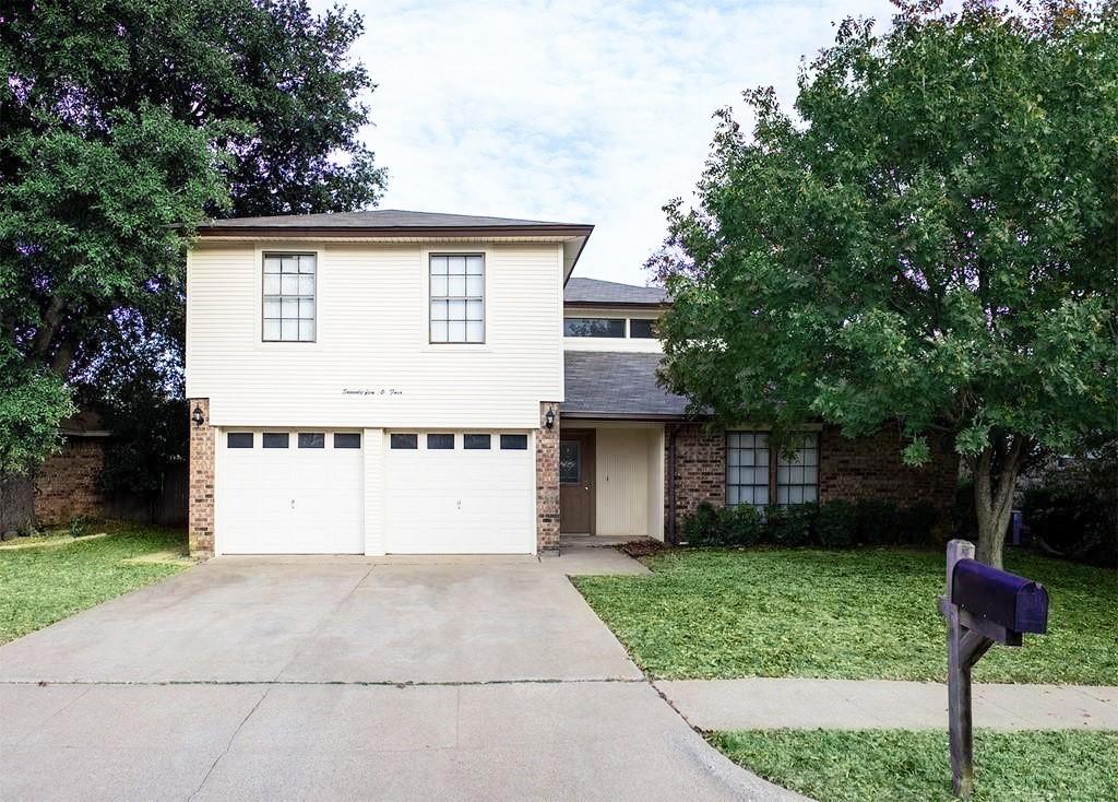 7504 Maple Hill Road Watauga, TX 76148 - Photo 1 of 1 a front view of a house with a yard and garage