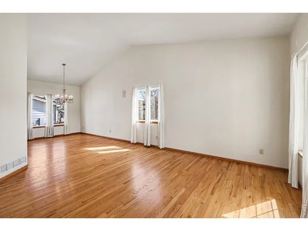 an empty room with wooden floor