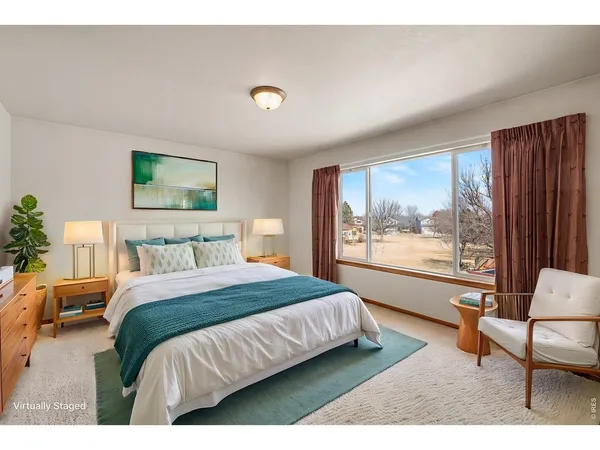 a bedroom with a large bed and a couch