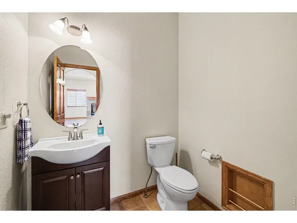 a bathroom with a sink toilet and mirror
