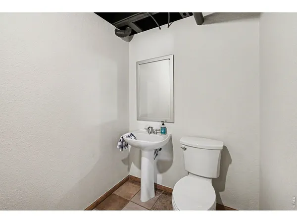 a bathroom with a sink toilet and a mirror