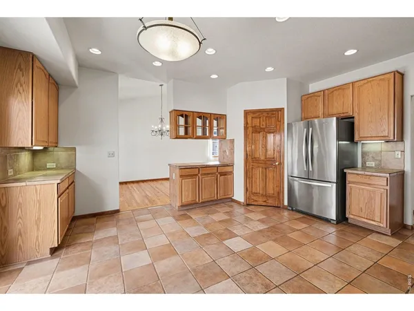 a kitchen with granite countertop a refrigerator and a sink