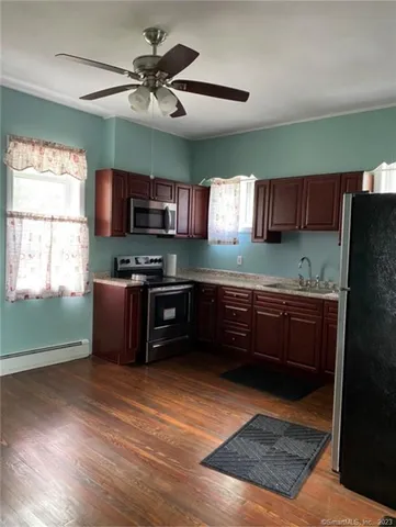 a kitchen with stainless steel appliances kitchen island granite countertop a refrigerator a stove a sink dishwasher and a microwave oven with cabinets