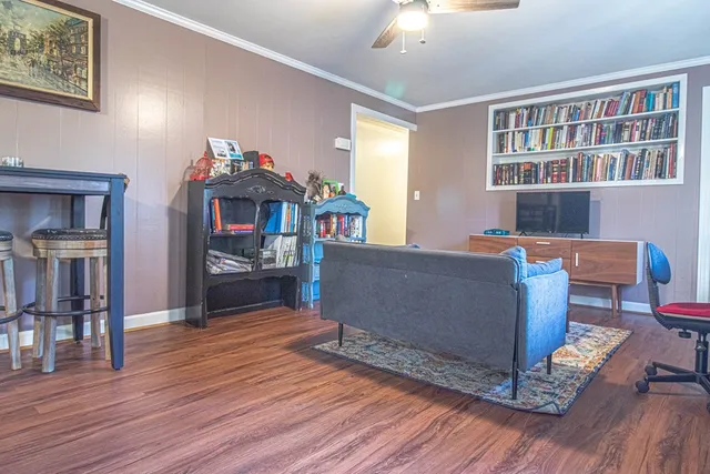 a living room with furniture and a wooden floor