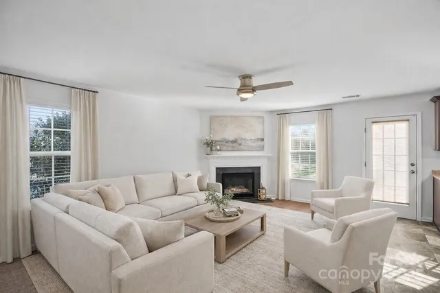 a living room with furniture and a fireplace