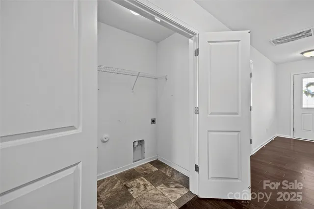 a bedroom with a bed and a potted plant