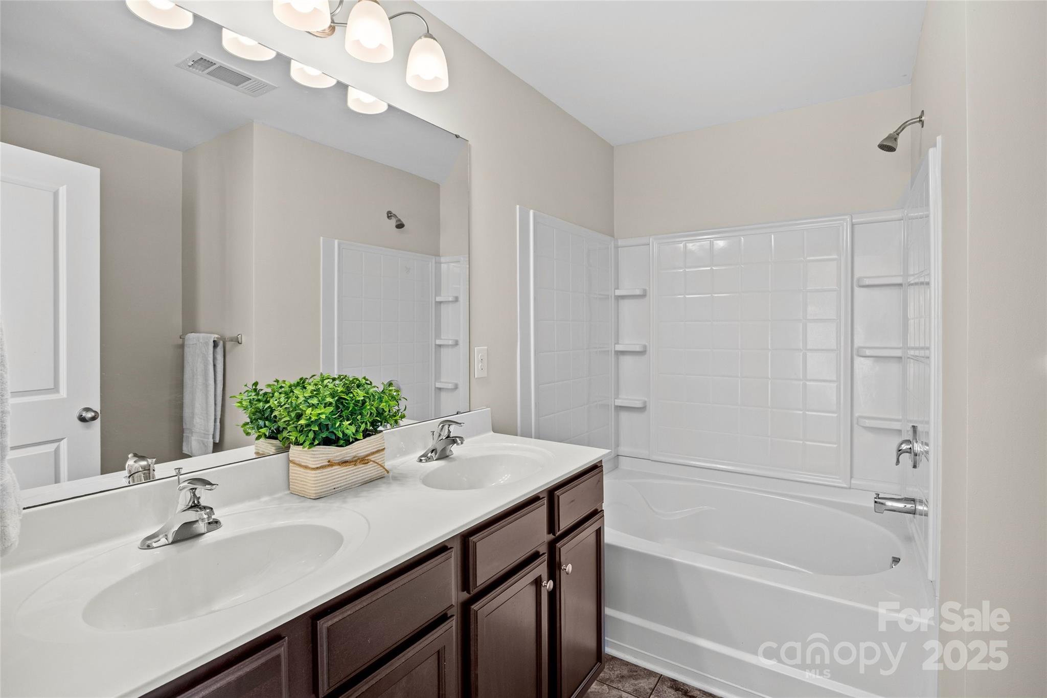 4146 Trowel Court Midland, NC 28107 - Photo 23 of 29 a bathroom with a sink double vanity granite tub shower and a mirror