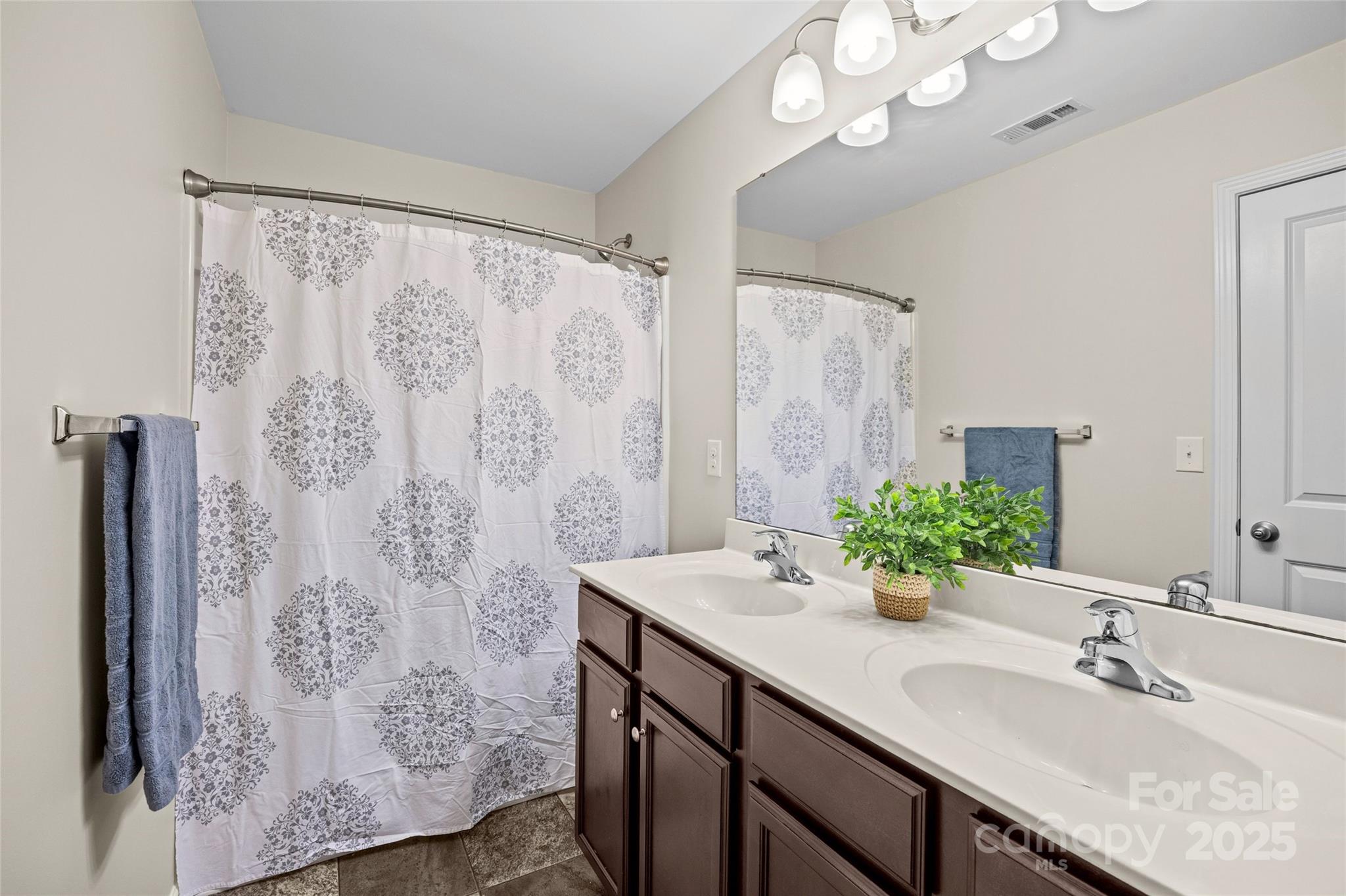 4146 Trowel Court Midland, NC 28107 - Photo 25 of 29 a bathroom with a granite countertop sink a large mirror and shower