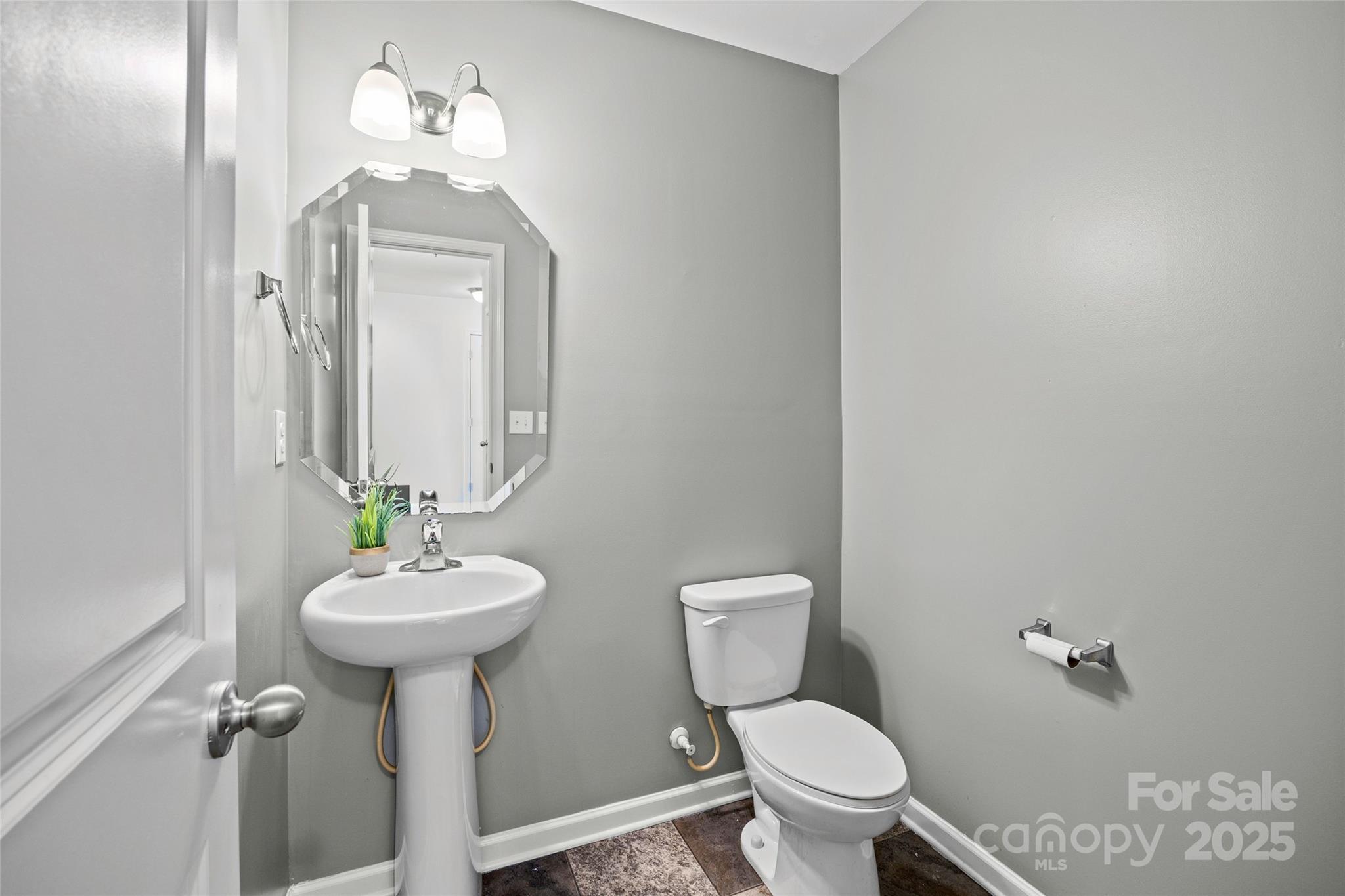 4146 Trowel Court Midland, NC 28107 - Photo 6 of 29 a bathroom with a toilet sink and mirror