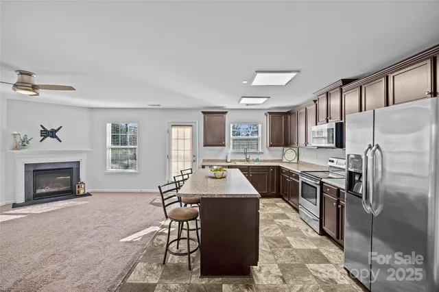 a kitchen with a stove a sink and a microwave