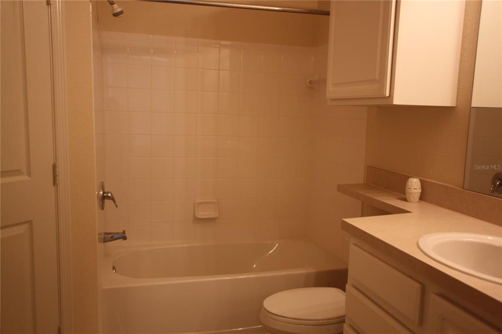 5811 Legacy Crescent Place, Unit 202 Riverview, FL 33578 - Photo 6 of 12 a bathroom with a sink a toilet and shower