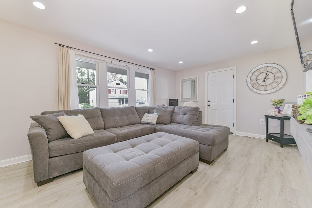 4 Scherig Circle, Unit 4 Methuen, MA 01844 - Photo 18 of 28 a living room with furniture a window and a clock