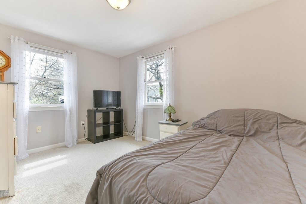4 Scherig Circle, Unit 4 Methuen, MA 01844 - Photo 20 of 28 a bedroom with a bed and a large window