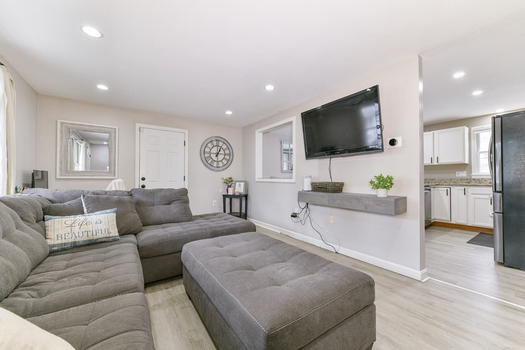 4 Scherig Circle, Unit 4 Methuen, MA 01844 - Photo 2 of 28 a living room with furniture and a flat screen tv