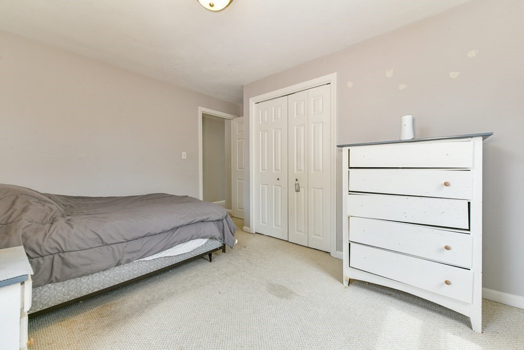4 Scherig Circle, Unit 4 Methuen, MA 01844 - Photo 21 of 28 a room with a bed and a dresser