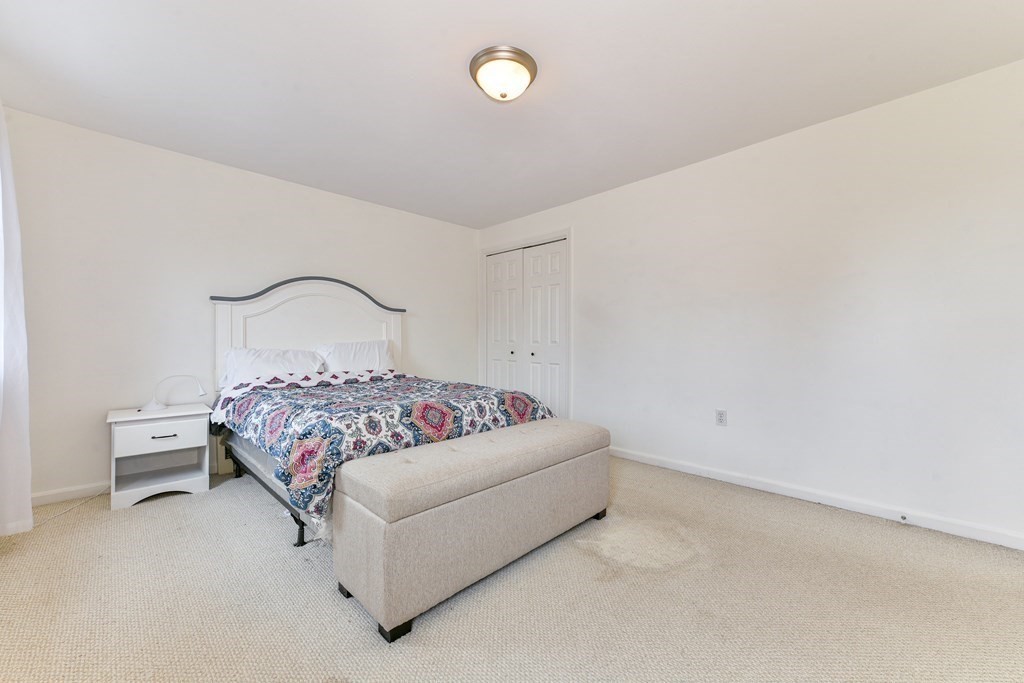 4 Scherig Circle, Unit 4 Methuen, MA 01844 - Photo 22 of 28 a bedroom with a bed and night stand
