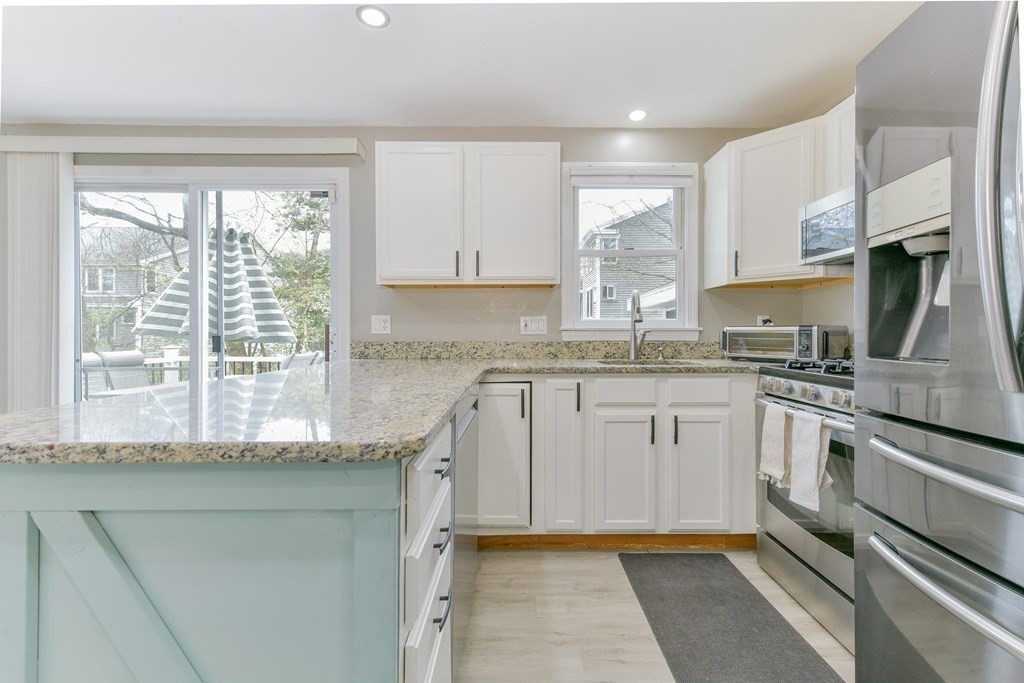 4 Scherig Circle, Unit 4 Methuen, MA 01844 - Photo 7 of 28 a kitchen with granite countertop a sink stainless steel appliances and cabinets
