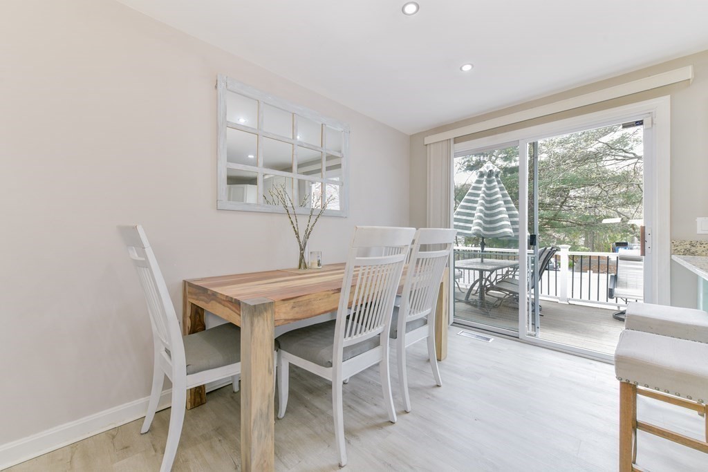 4 Scherig Circle, Unit 4 Methuen, MA 01844 - Photo 9 of 28 a view of a dining room with furniture wooden floor and chandelier