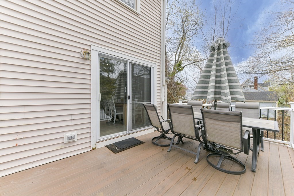 4 Scherig Circle, Unit 4 Methuen, MA 01844 - Photo 10 of 28 a view of a chairs and table in a back yard of the house
