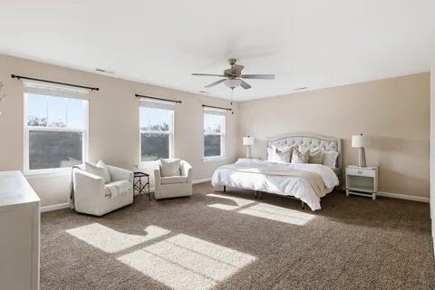 a spacious bedroom with a bed and a couch