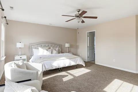 a bedroom with bed and window