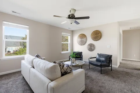 a living room with furniture and a large window