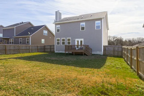 a view of house with a yard