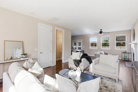 a living room with furniture and wooden floor