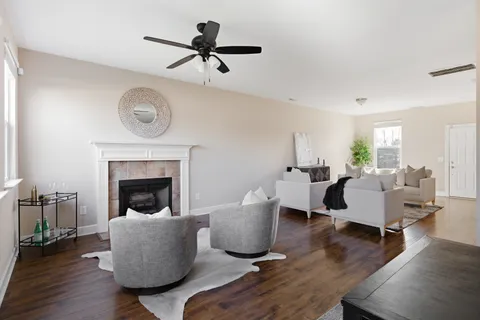 a living room with furniture and a fireplace