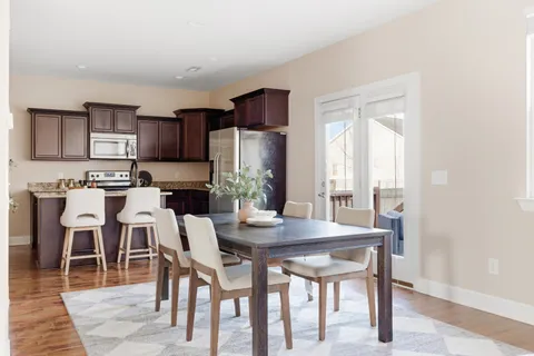 a view of a dining room with furniture and wooden floor