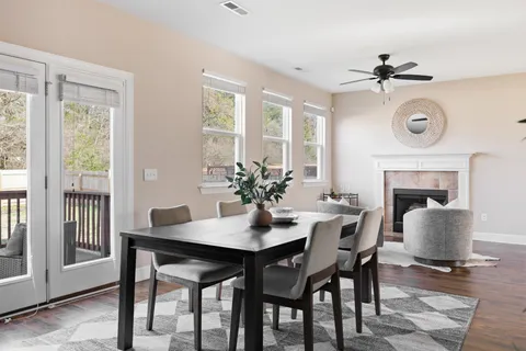 a dining room with furniture a fireplace and a chandelier