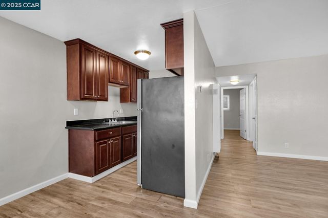 a view of kitchen with wooden floor
